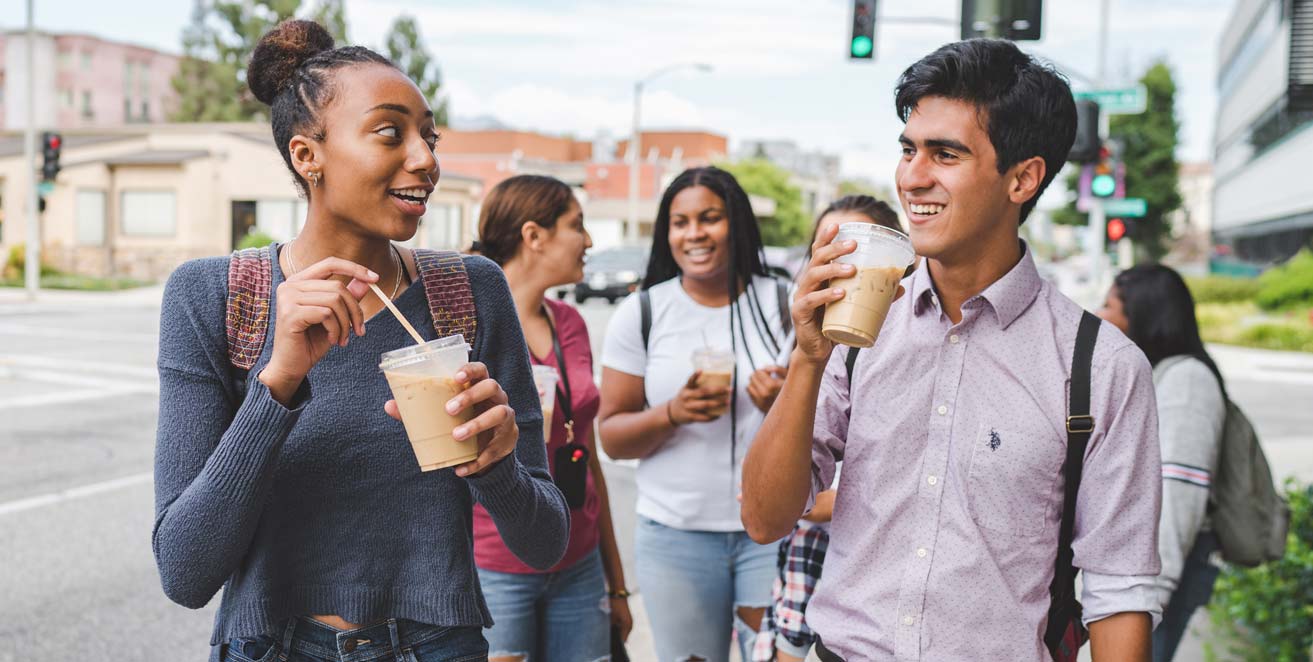 Students walking and drinking coffee
